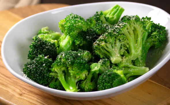 Steamed vegetarian side of broccoli served with light seasoning