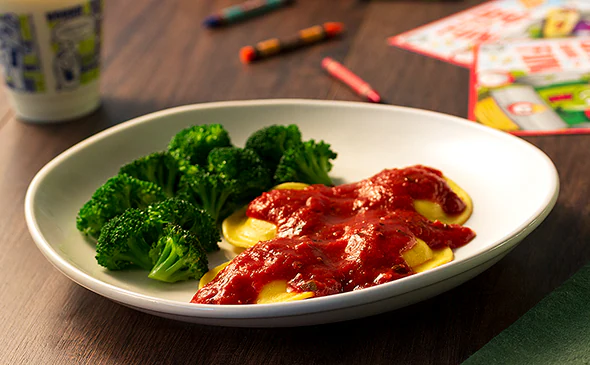 Kids vegetarian cheese ravioli served with marinara sauce and parmesan cheese
