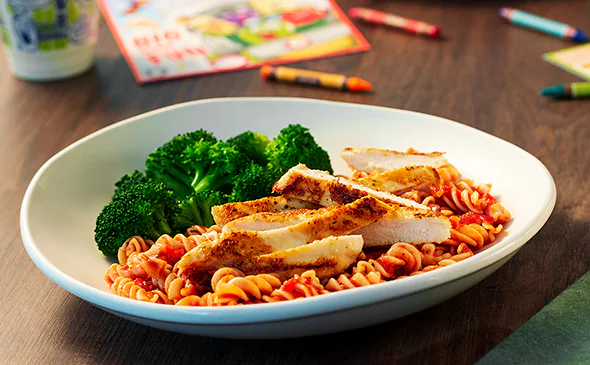 Grilled chicken with rotini pasta and marinara sauce kids meal served hot