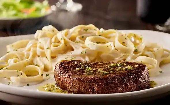 Juicy 6 oz sirloin steak grilled to perfection, served with herbs and garlic butter