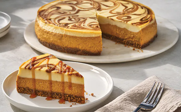 Limited time pumpkin cookie butter cheesecake topped with whipped cream and cookie crumbs