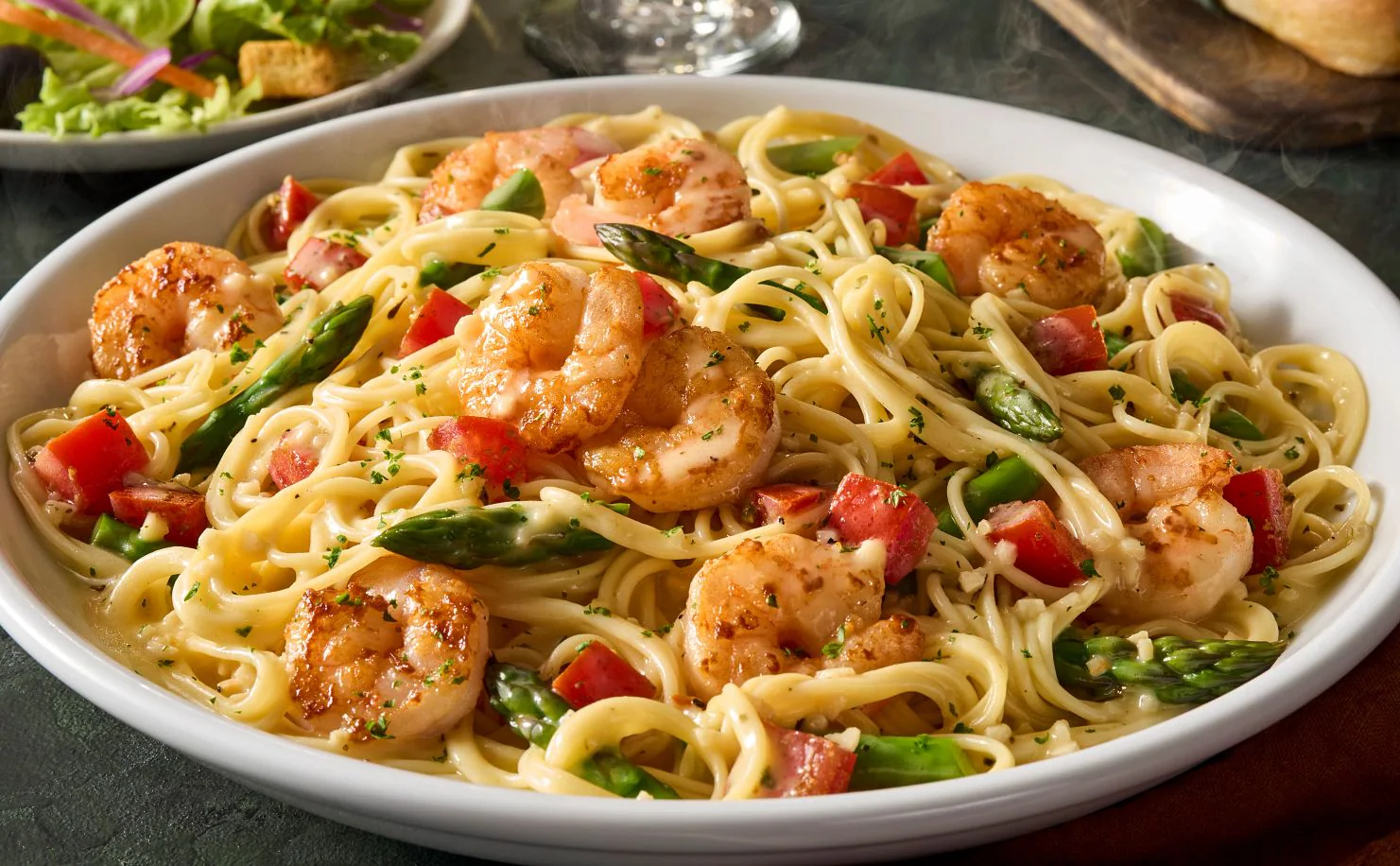 Shrimp scampi pasta tossed in garlic butter sauce with lemon, herbs, and parmesan cheese