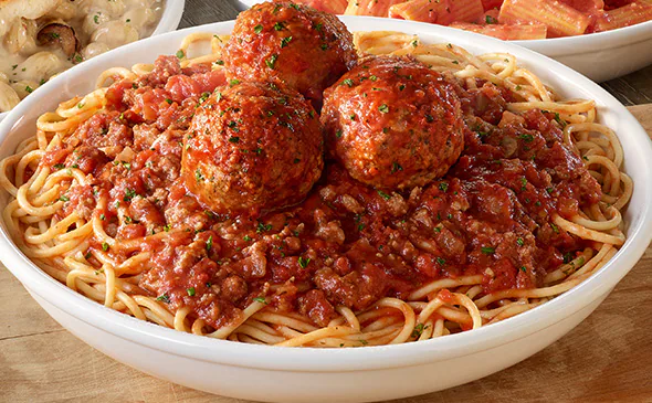 Classic spaghetti and meatballs topped with marinara sauce and parmesan cheese