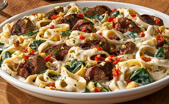 Steak gorgonzola alfredo pasta topped with grilled steak, creamy alfredo sauce, and gorgonzola cheese