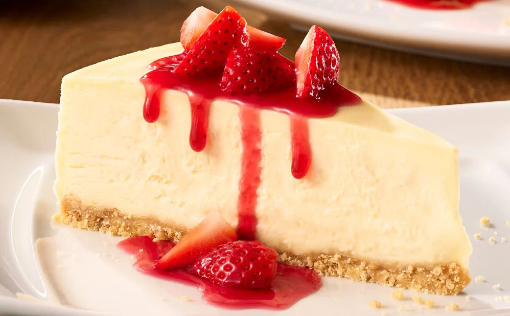 Creamy vegetarian Sicilian cheesecake topped with fresh strawberries and sauce