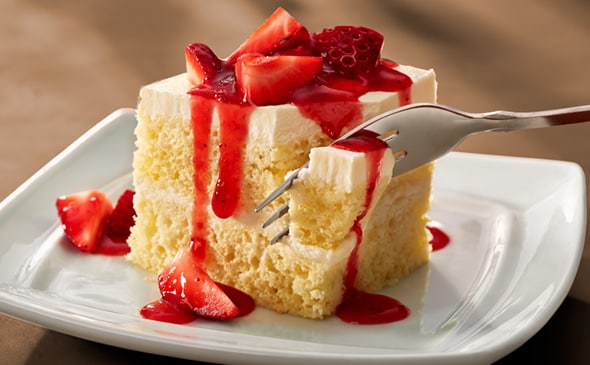 Delicious vegetarian strawberry cream cake layered with whipped cream and fresh strawberries