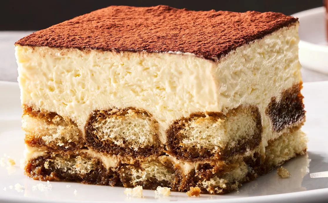 Classic vegetarian tiramisu dessert layered with coffee-soaked ladyfingers and mascarpone cream