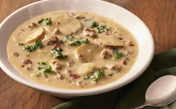 Classic Zuppa Toscana soup made with sausage, potatoes, and kale served hot