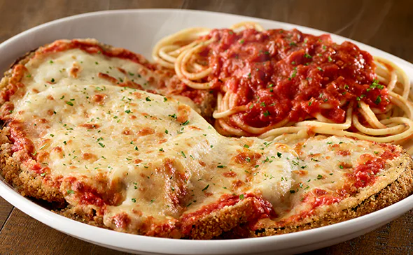 Vegetarian eggplant parmigiana layered with marinara sauce, mozzarella, and parmesan cheese