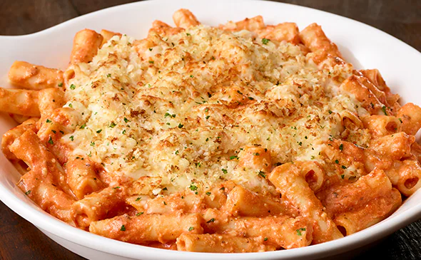 Baked five cheese ziti al forno with creamy marinara sauce, melted cheese, and Italian herbs