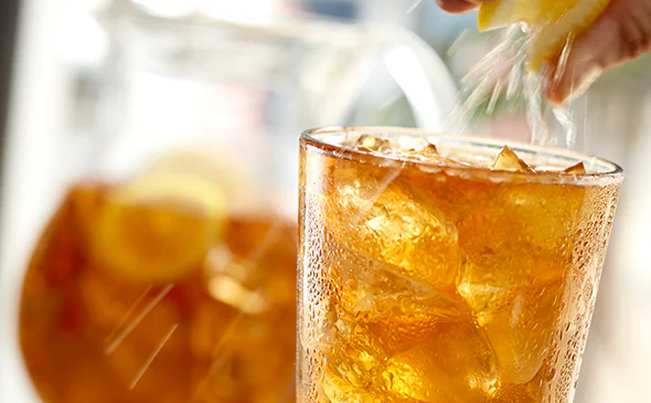 Refreshing fresh brewed iced tea served cold with ice and lemon slice