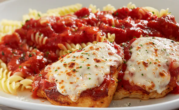 Grilled Chicken Parmigiana topped with marinara sauce and melted mozzarella cheese
